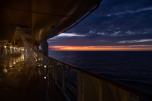 Dramatic sunrise and cloud formations over the sea near Dover, Southern England with the deck of an empty ship