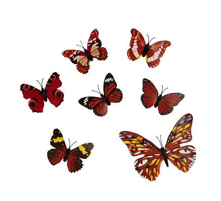some colorful plastic butterflies on a white background