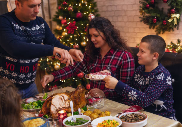istock Father carving stuffed roasted turkey for Christmas dinner 1435958221