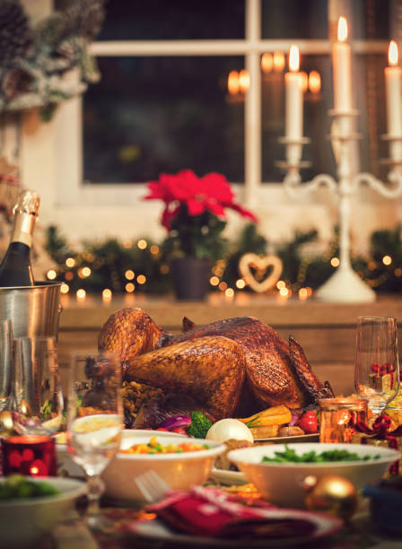 Traditional Stuffed Christmas Turkey with Side Dishes Table is set up for Holiday dinner. On the table is a traditional stuffed roasted turkey with side dishes and Christmas decoration sauces table turkey christmas stock pictures, royalty-free photos & images