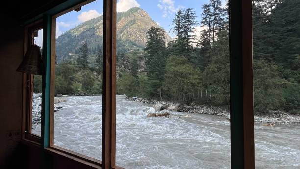 istock Beautiful view of a flowing river surrounded by trees and a mountain from a hostel window 1435964892
