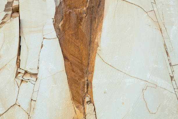 istock Abstract texture of smooth yellow stone, cracked rock for background 1435965597