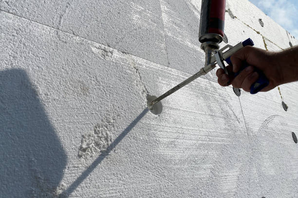 istock Insulation of the house with polystyrene foam, a worker insulates the house with polyurethane foam 1435965613