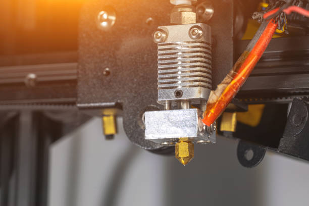 istock Close-up of a 3D printer printhead, hotend and extruder from a 3D printer 1435965623