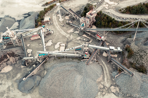 Aerial view of quarry, stone crusher, stone sorting conveyor belts, heavy industry