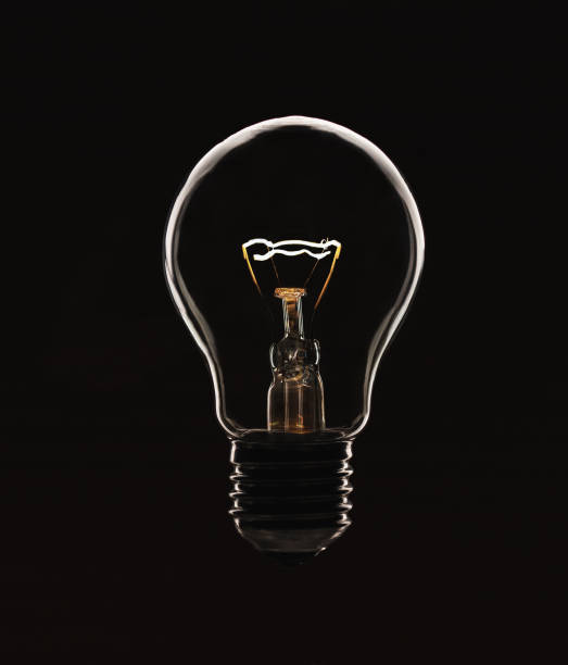 istock A glowing electric light bulb in a counter light on a black background 1435978590