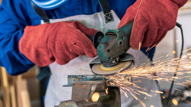 istock Craftsman grinding metal with disk grinder in workshop. Worker cleaning a steel 1435981998