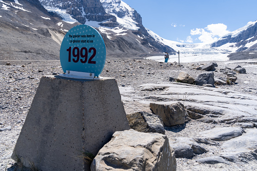 Alberta, Canada - July 12, 2022: Historical marker and sign showing the amount Athabasca Glacier has receeded since 1992