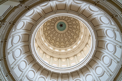 Austin, Texas - May 23, 2022: Inside the rotunda of the Texas State Capitol Building, the domed ceiling with the word Texas and lone star.