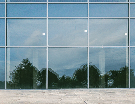 scenery reflection on brand new commercial office building glassy facade