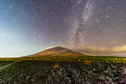 Short star trails and the Milky Way clear night sky over Mt. Iwate with lava rock field that exploded out of Mt. Iwate in 1732.