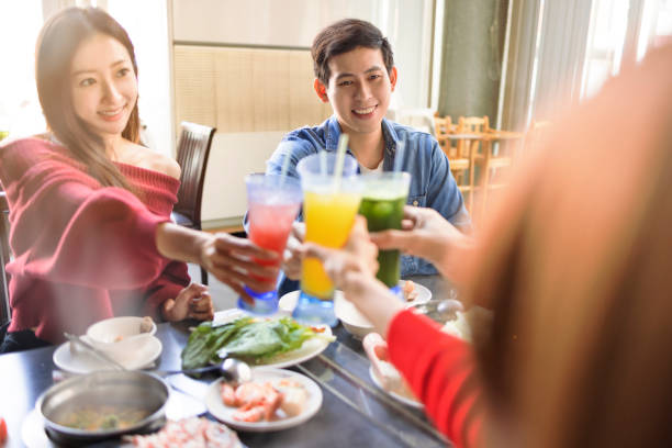 istock Happy Young people toasting and having dinner in hot pots  restaurant 1435991322