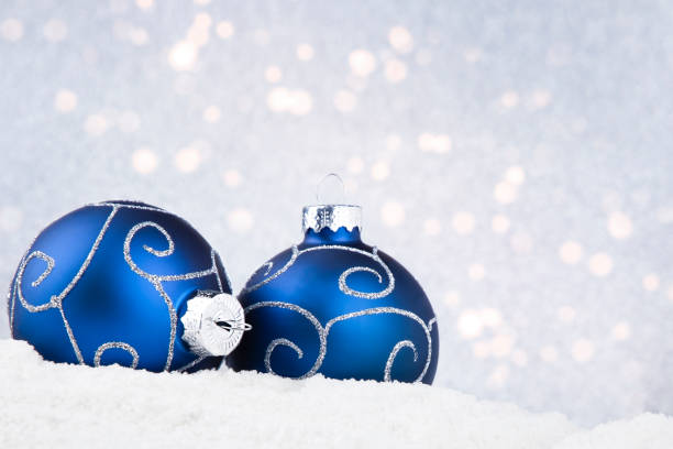 istock christmas background with blue balls on snow and bokeh 1435993219