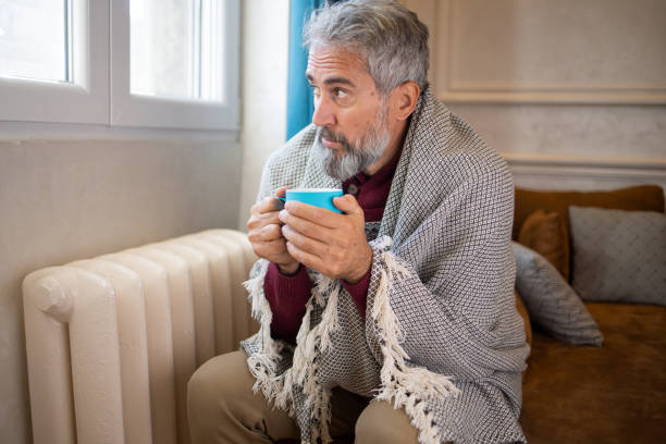 istock Senior man feel cold in home with no heating 1435993815