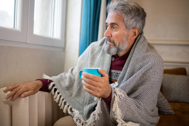 istock Senior man feel cold in home with no heating 1435993816