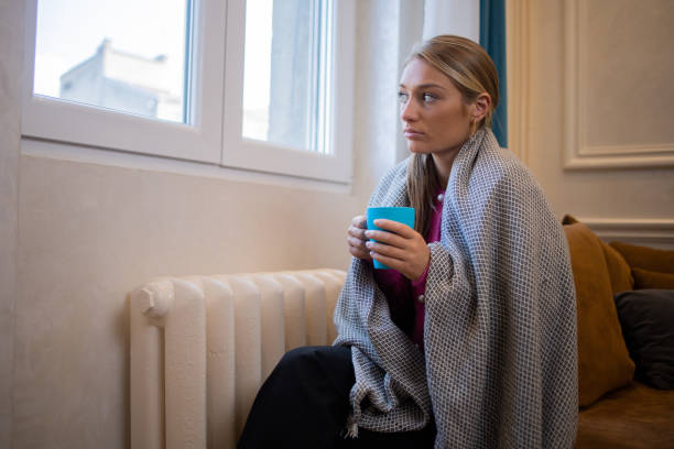 istock Woman feel cold in home with no heating 1435993837