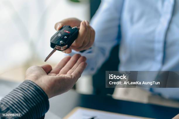 Of The Representative Hold The Car Keys To The New Owner After Signing The Leasing Contract In The Car Sales Contract Document Stock Photo - Download Image Now