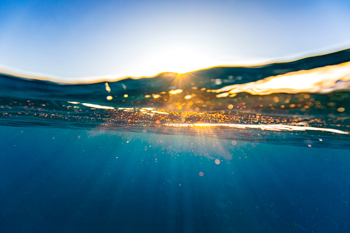 Nature background of surface level in the ocean with bright rays