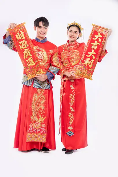Man and woman wear Cheongsam suit celebrate chinese new year with chinese greeting card