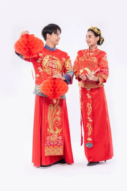 Man and women wear cheongsam smiling to get - get with nice red lamp and gift money