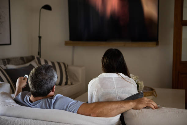 istock Argentinean couple watching TV at home 1436010533