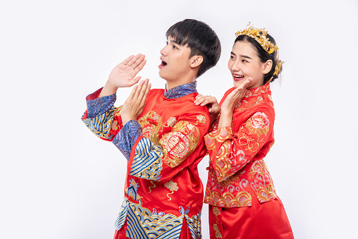 Man and woman wear Cheongsam suit Shout surprising promotion event in chinese new year