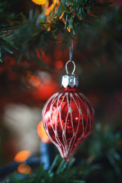 istock Christmas ornaments hanging in a Christmas tree 1436012334