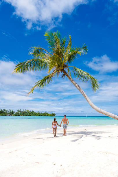 istock Couple walking on a tropical beach in Thailand 1436012518