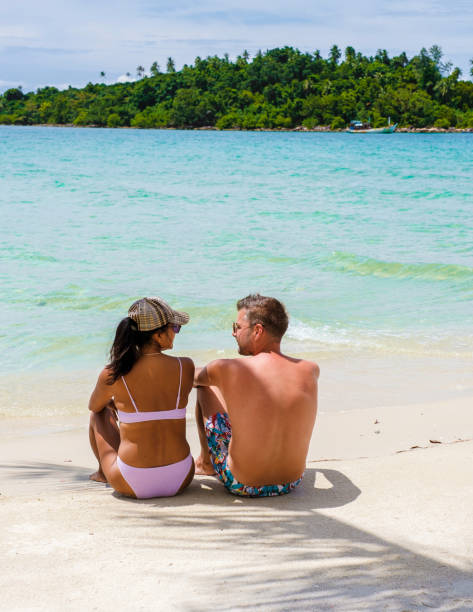 istock Couple relaxing at a tropical beach 1436012541
