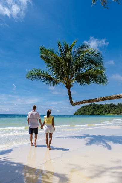 istock Couple walking on a tropical beach in Thailand 1436012579