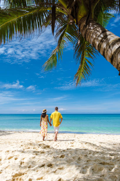 istock Couple walking on a tropical beach in Thailand 1436012795