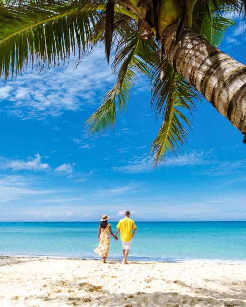 istock Couple walking on a tropical beach in Thailand 1436015532