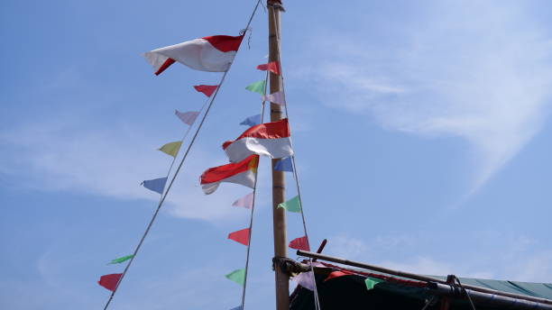 istock Indonesian national flag fluttering against the cloudy sky background 1436015664