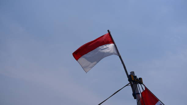 istock Indonesian national flag fluttering against the cloudy sky background 1436015671