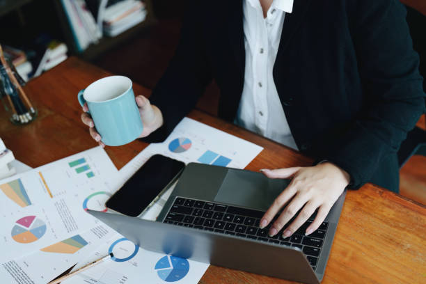 istock Portrait of a young woman drinking coffee while using a computer 1436015768