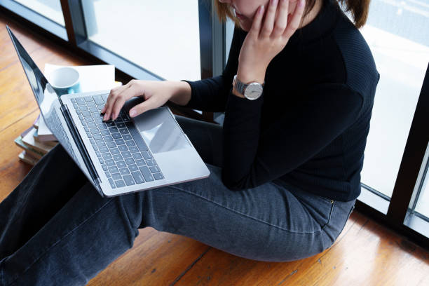 istock Portrait of an Asian woman using a computer to study online and drinking coffee while video conference 1436016577