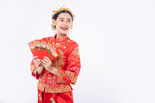 Woman wear Cheongsam suit smile to get gift money from family in chinese new year