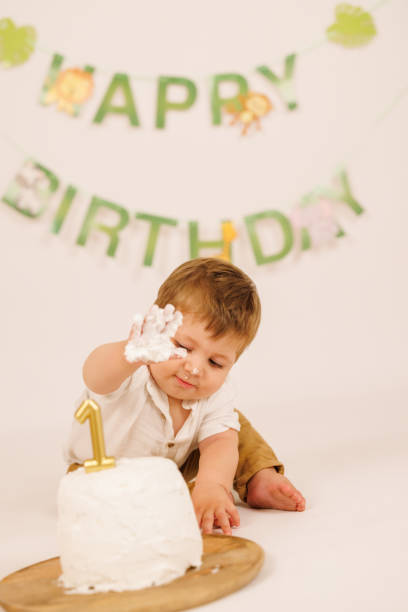 istock Cute baby boy eating his birthday cake with hands 1436017775