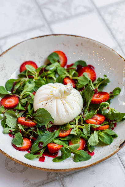 istock Strawberry Fields Salad, vegetables salad and white background 1436019104
