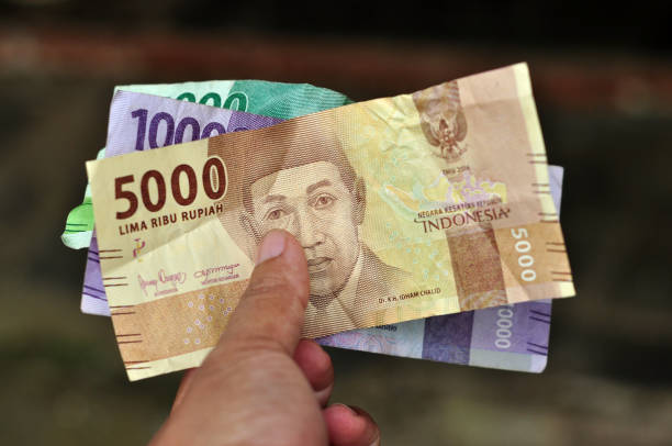 istock Hold Indonesia rupiah banknote money for trade transaction 1436020265