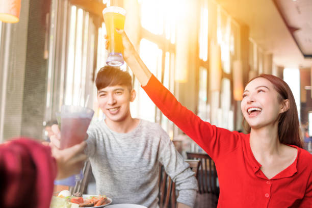 Young people toasting and celebrating  at  restaurant