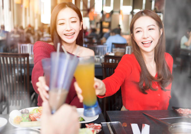 Young people toasting and celebrating  at  restaurant