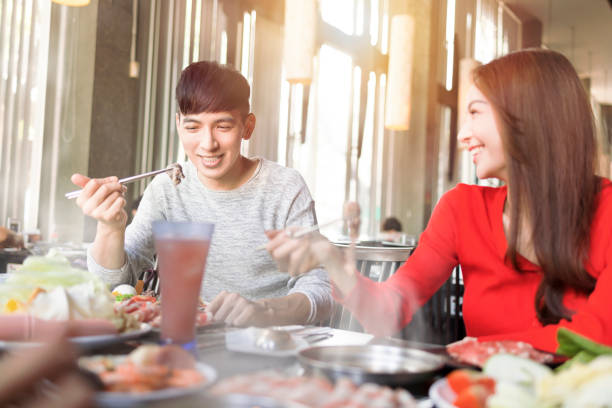 istock Happy young couple have dinner  in the hot pot restaurant 1436020593
