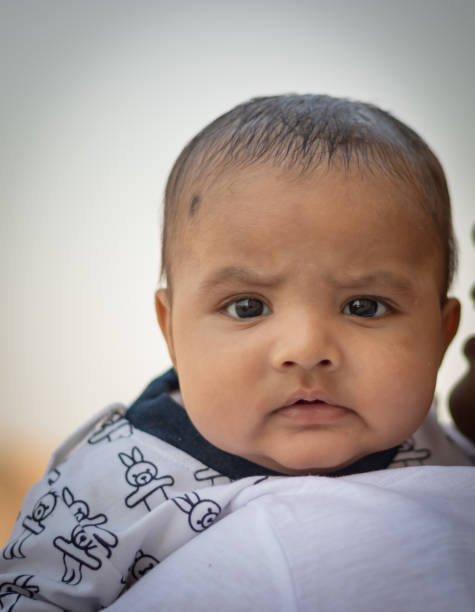 istock cute infant facial expression resting at mother shoulder from flat angle 1436029134