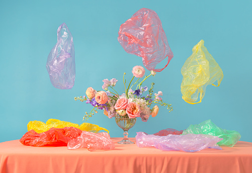 Flower decoration in a glass vase, pastel colors with plastic bags