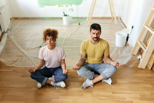 istock Relaxed couple meditating during home renovation process. 1436030066