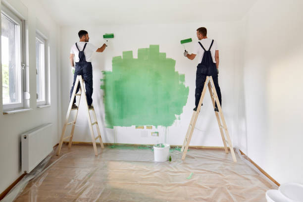 istock Back view of house painters working on home renovation process. 1436030165