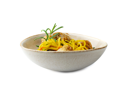 Egg ramen noodles with spring rolls in bowl isolated. Asian yellow pasta with vegetables and rollos primavera on white background