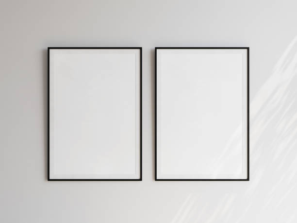 istock Pair of black empty picture frames with portrait orientation hanging on white wall. Template for your content. 3D illustration. 1436030933