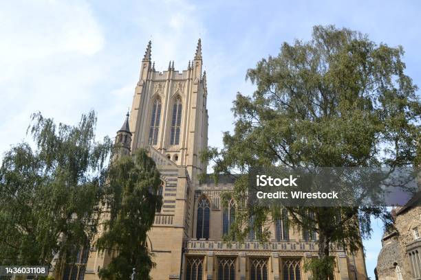 Lowangle View Of Bury St Edmunds Abbey Building And Trees Under The Blue Sky Stock Photo - Download Image Now